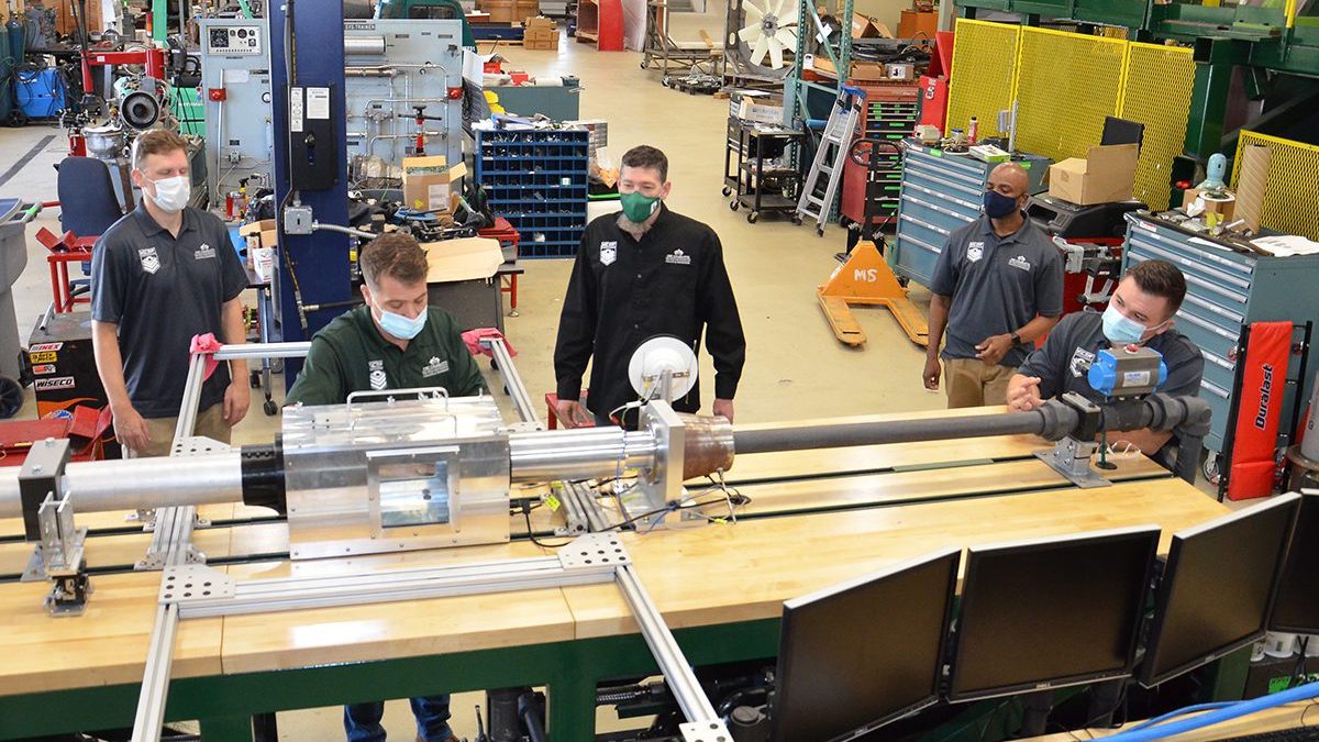 Dr. Dahlberg and military veteran students from the William States Lee College of Engineering with the hypersonic wind tunnel project.