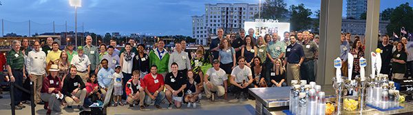 A large group gathers for a group photo at a Charlotte Knights game.
