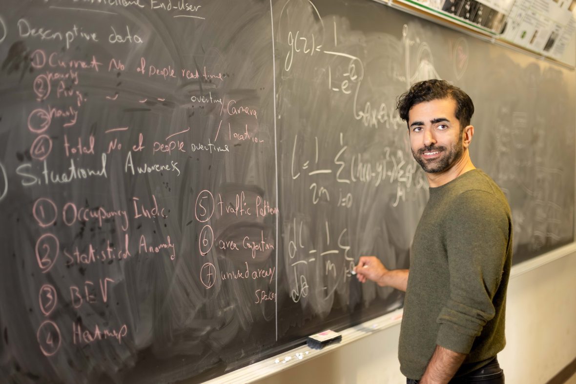 Professor writing formulas on a chalkboard