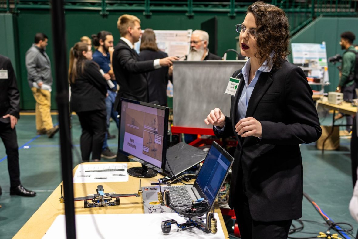 Senior Design Student giving a presentation at a conference
