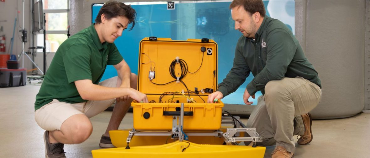 Faculty and students working with marine equipment