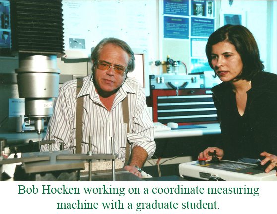 Bob Hoken working on a coordinate measuring machine with a graduate student