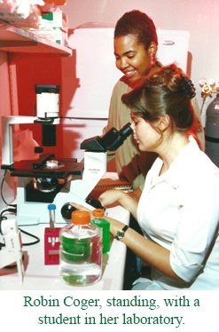 Robin Coger standing with a student in her Lab