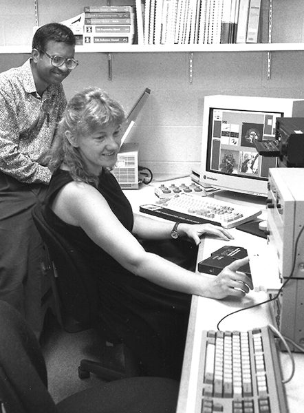 faculty working with student in a computer lab
