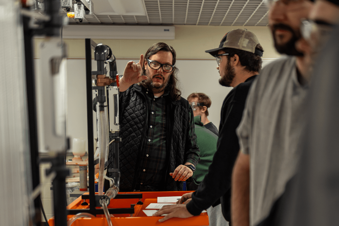 Professor and students in the Thermal Fluids Lab