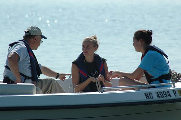 Regina Guyer and student on a boat