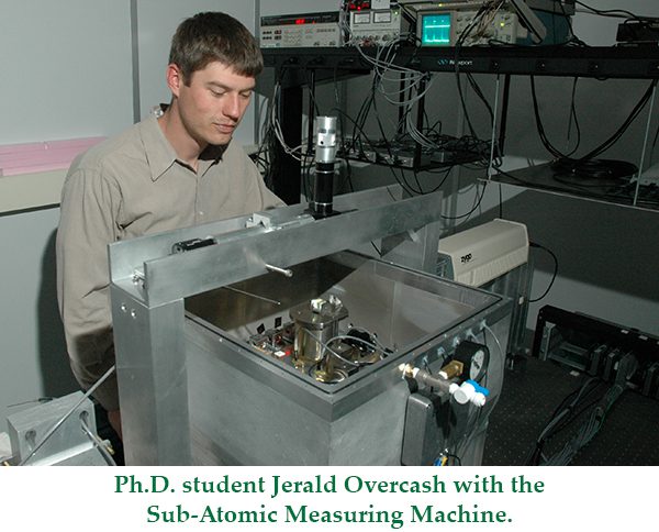 Ph.D. student Jerald Overcash with the sub-atomic measuring machine