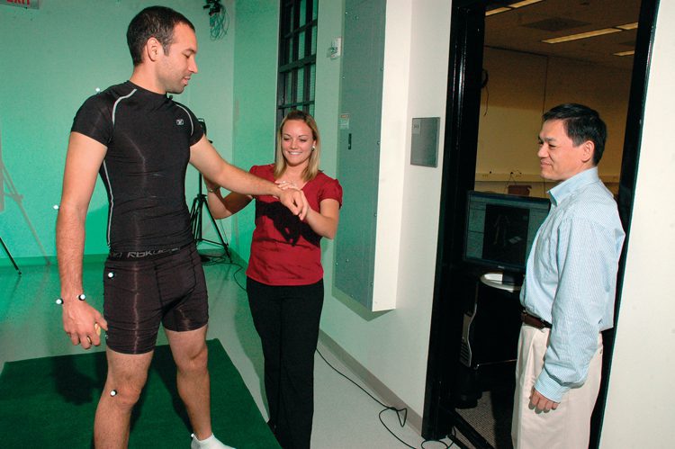 Dr. Nigel Zheng, right, and students working on a motion study.