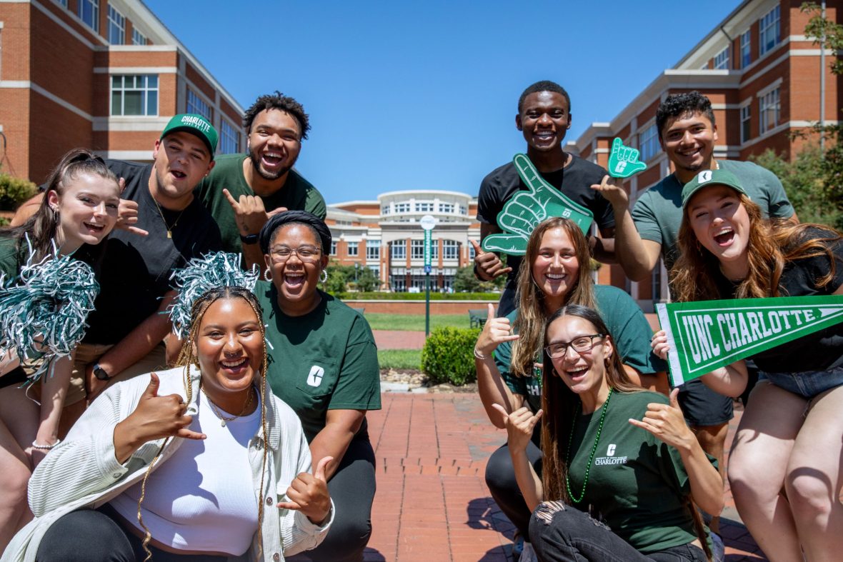 Group of students wearing charlotte apparel posing for a photo