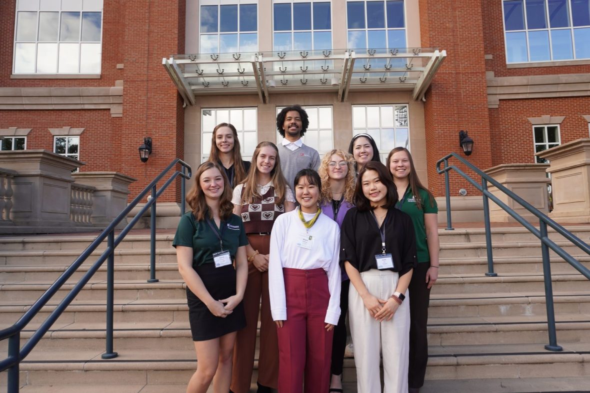 Ambassador students posing in front of a building