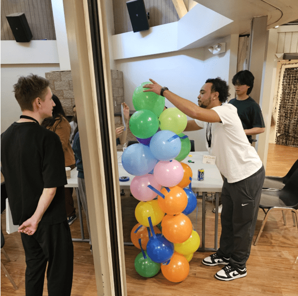 student hanging baloons
