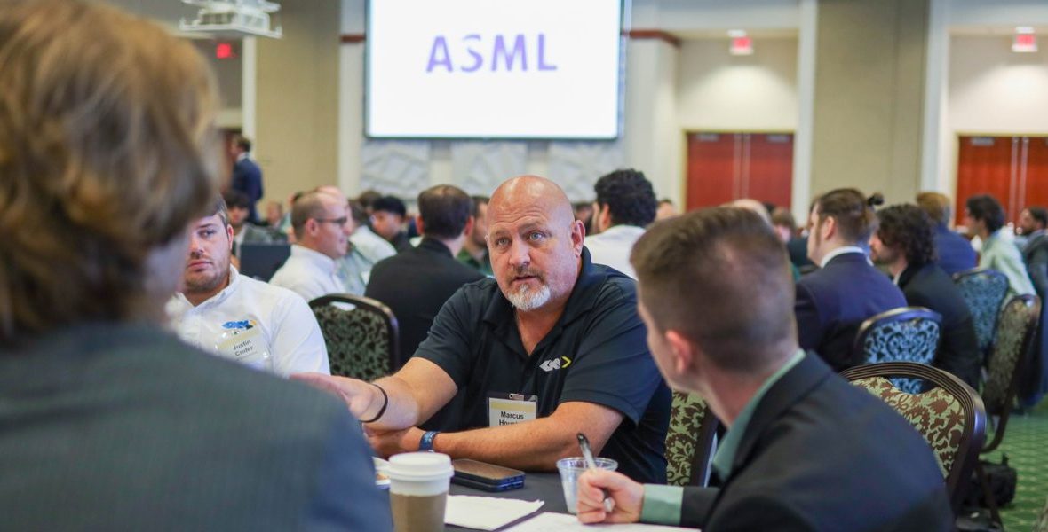 Group of engineers at the ASML conference sitting at a table