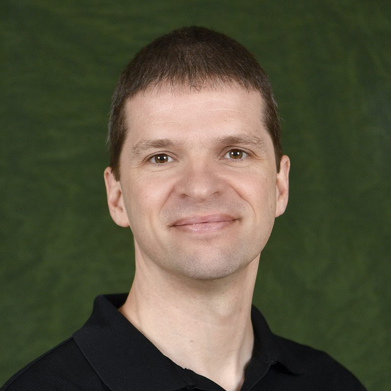 Portrait of James Amburgey against a green backdrop