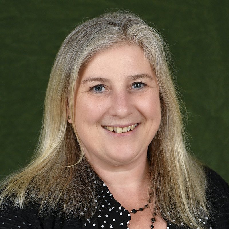 Smiling portrait of Brigid Mullany wearing a black and white polka dot shirt