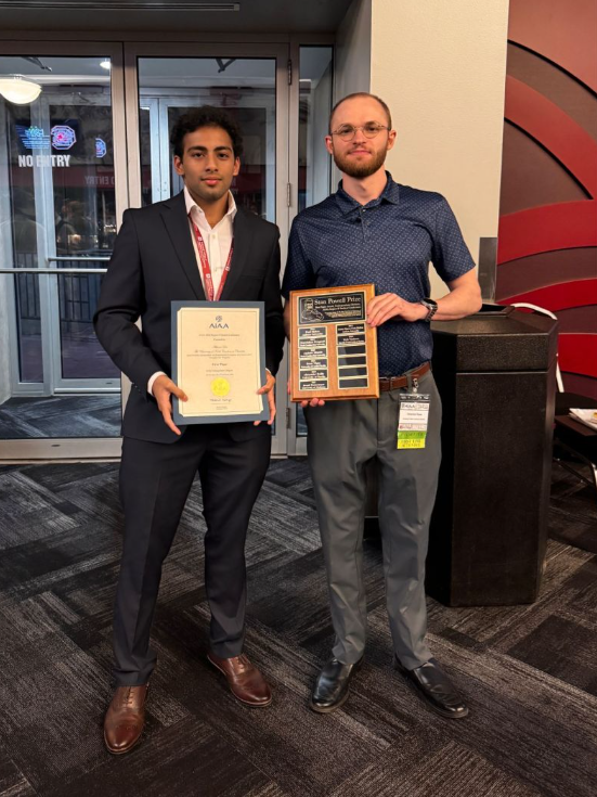 Undergraduate Students Abhinav Das and Sebastian Mares stand together holding their awards