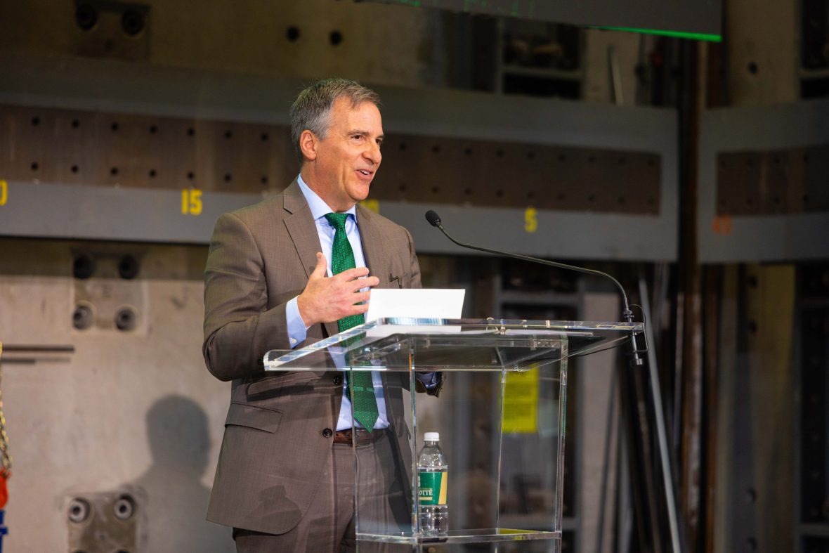 Craig Albert ’85 speaks from a podium at Albert School of Construction announcement event