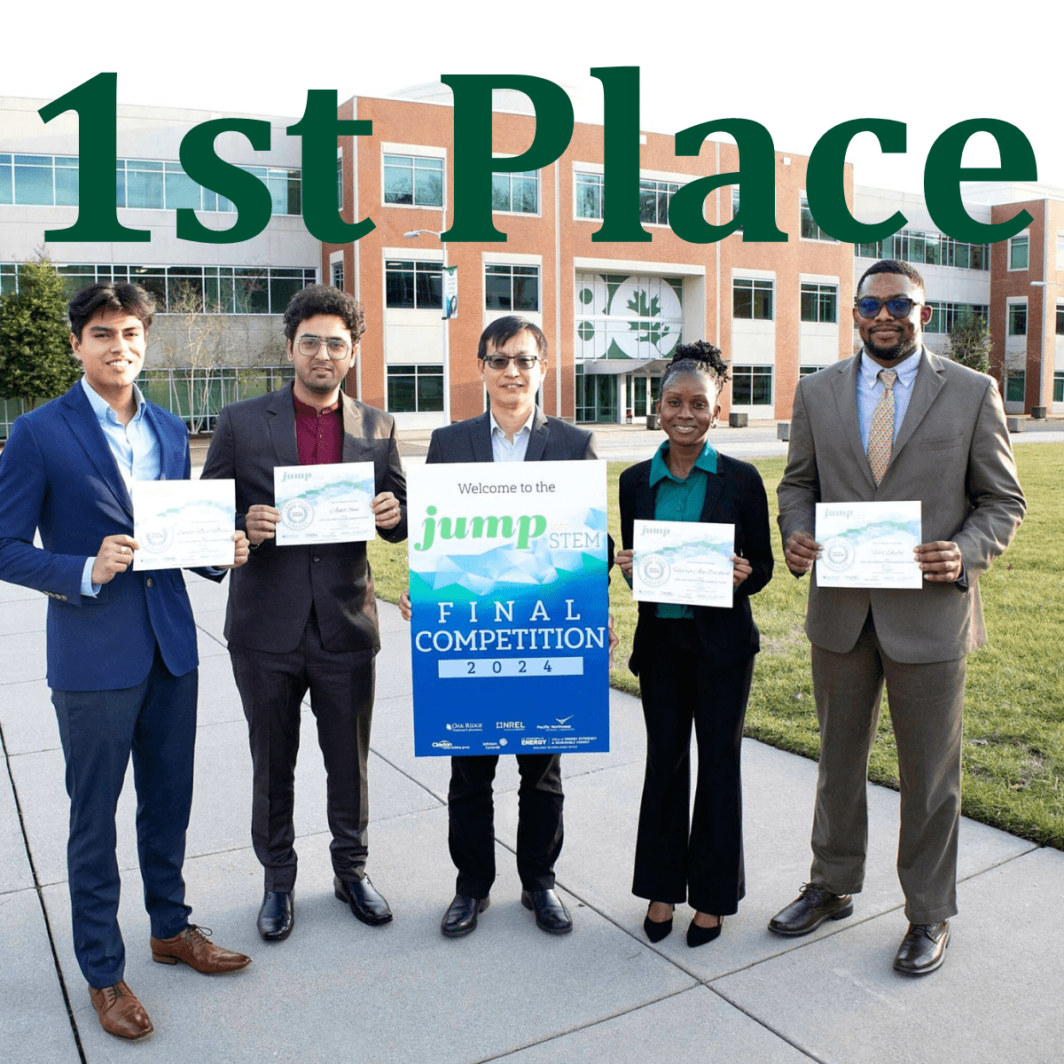 A group of students and a professor stand outside a building on a sunny day, holding competition certificate awards.
