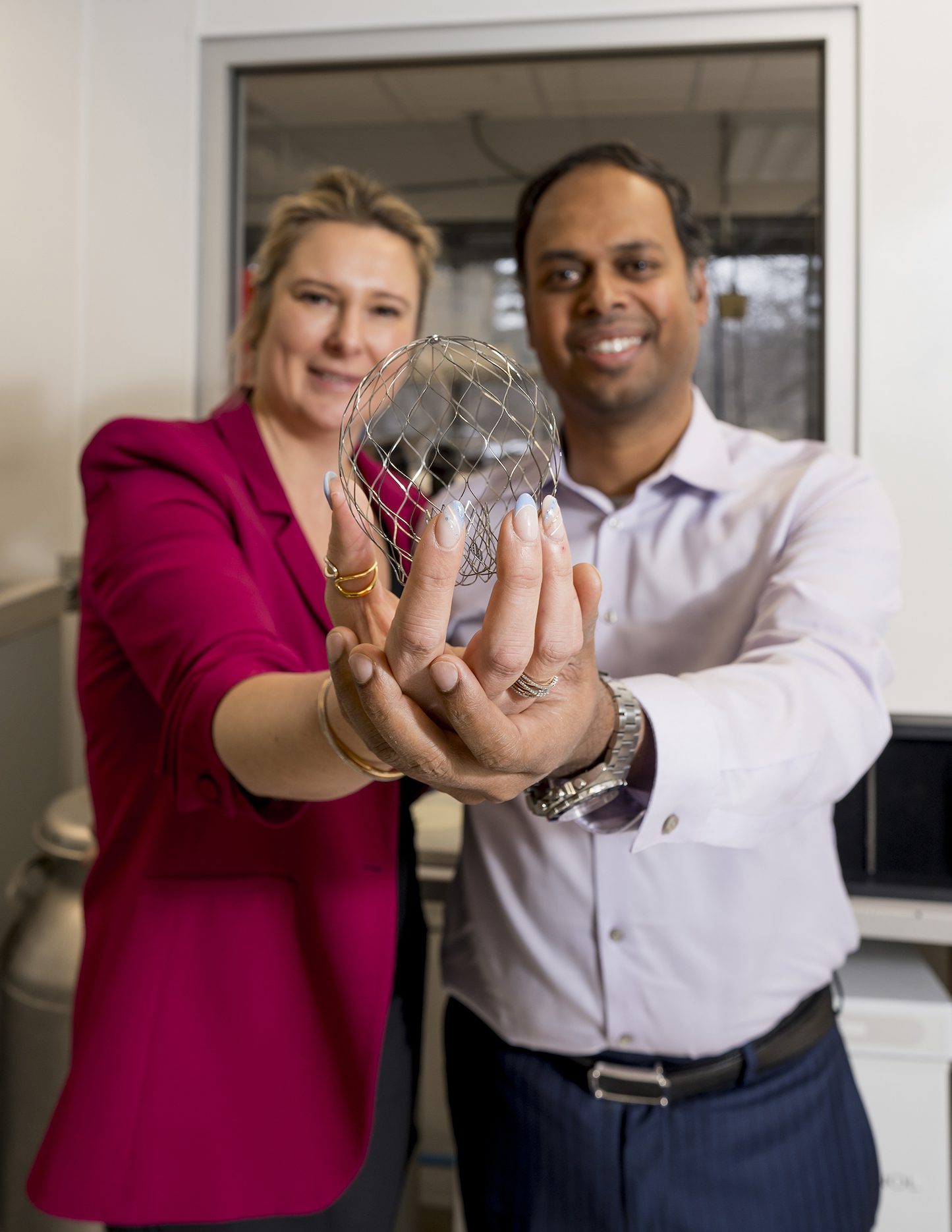 Katherine and Saravana Kumar holding the AltaValve medical device