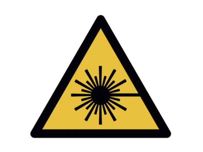 black sunburst icon inside a yellow triangle with a black border
